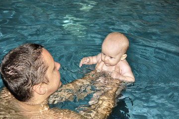 baby with daddy in swimmingpool