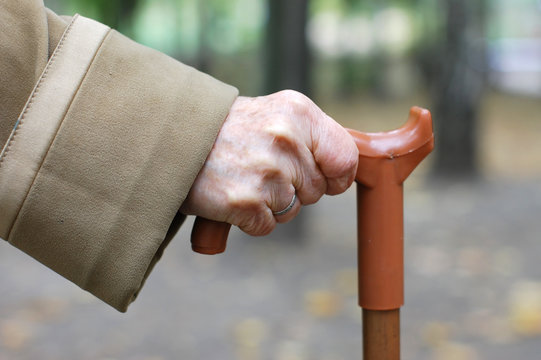 Old Woman Hand Leans On Walking Stick