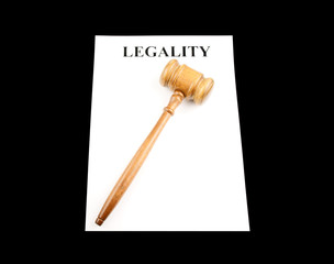 Gavel on white paper isolated on black