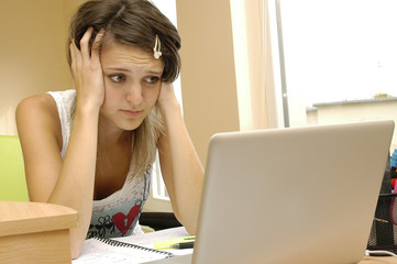 Disappointed girl in front of computer