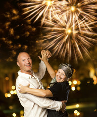 Middle-aged couple dancing waltz at night ....