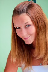 Fototapeta premium Lovely redhead on green background