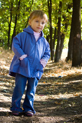 Cute little girl walks in the wood