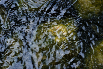 Boulders and ripples in water