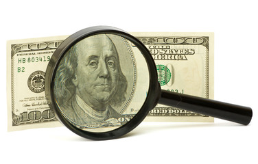Dollars with magnifying glass