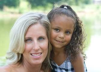 Obraz premium A mother and her mixed race daughter enjoying the park