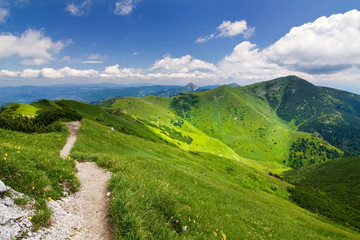 Fototapeta premium Mountain-ridge and blue sky with white clouds