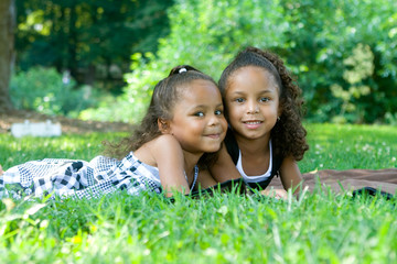 Two beautiful mixed race sisters enjoying the park