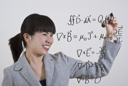 woman writing maxwell equations