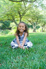 Naklejka na ściany i meble A beautiful mixed race child enjoying the outdoors