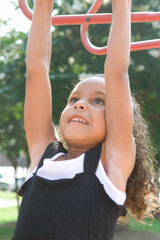 A beautiful mixed race child enjoying the playground