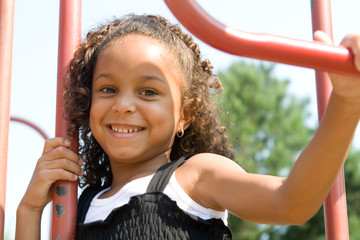A beautiful mixed race child enjoying the playground