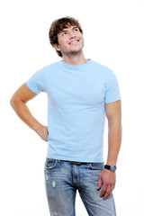 Fototapeta premium Beautiful handsome guy in casuals looking up - white background