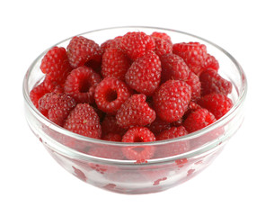Ripe raspberries in a glass bowl isolated on white