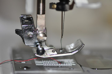 Embroidery machine foot showing needle and thread