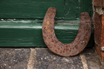 old horseshoe near green barn door