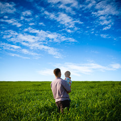 Fototapeta na wymiar father and son on green field