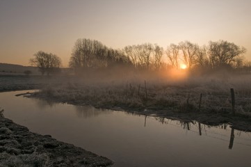 Obraz premium lever du jour sur une pâture gelée en hiver
