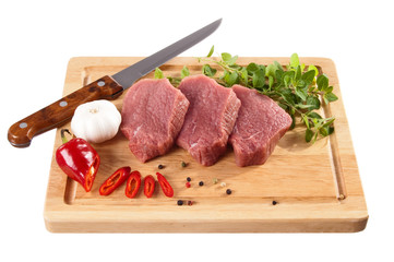Raw beef on cutting board isolated on white background