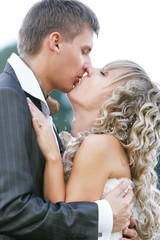 kissing couple on their wedding day