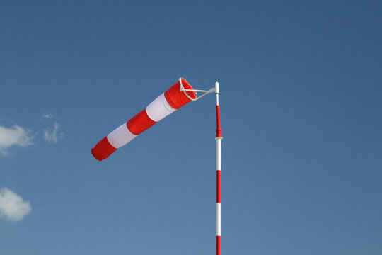 Red-white striped windsock on a pole