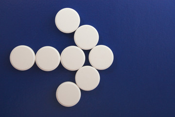 arrow of white tablets