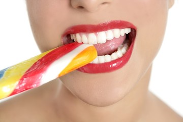 Fototapeta premium Colorful Lollypop in perfect woman teeth