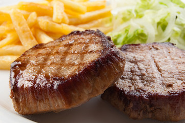 Grilled meat and, fries and  vegetable salad