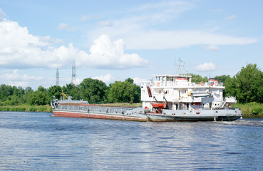 Big ship on the river under blue sky