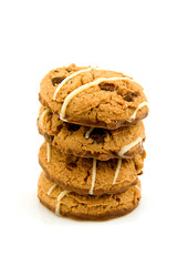 stacked chocolate chip cookies over white background