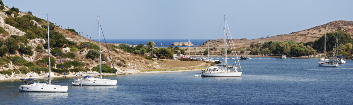 panorama of sailboats at anchor in a safe bay