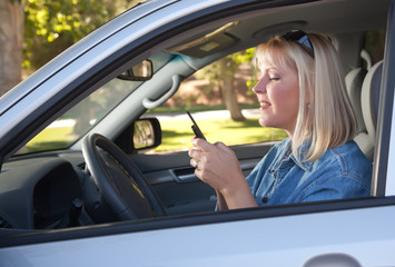 Fototapeta na wymiar Woman Text Messaging While Driving