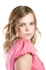 Headshot portrait of teenage girl in pink blouse