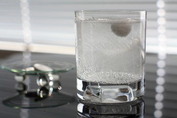 tablet dissolving in a glass of water