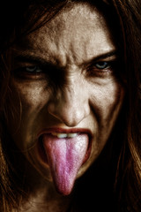Evil scary sinister woman with tongue out
