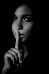 Shh secret concept with finger over lips