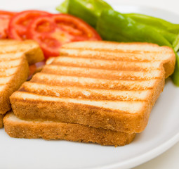 Delicious toasts with sliced tomatoes and green peppers
