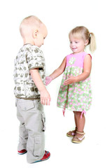 studio shot of boy and girl playing together