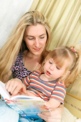 Mother and little girl reading