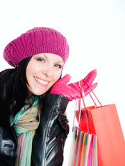 smiling brunette woman in fall clothes holding shopping bags