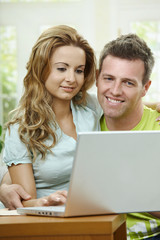 Couple using laptop computer