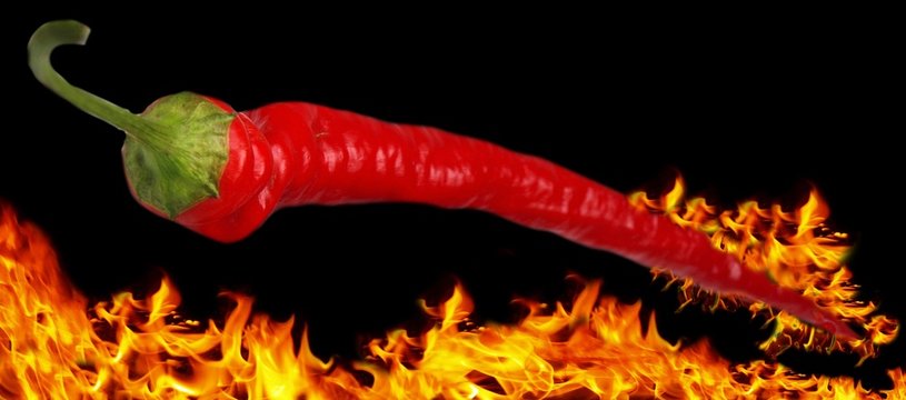 Flaming chili pepper on flaming background
