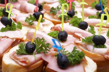 Ham sandwiches with olives and greens