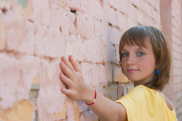 The girl at a brick wall