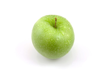 Fresh juicy green apple with water drops over white background