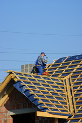 Man building construction roof