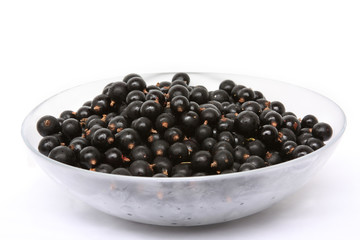 Fresh black currant in a glass bowl
