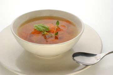 carrot soup in a bowl and spoon