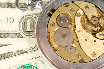 Fototapeta na wymiar Watch mechanism and dollar bills (Time Is Money concept)