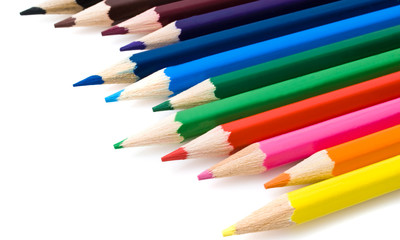 Assortment of coloured pencils with shadow on white background